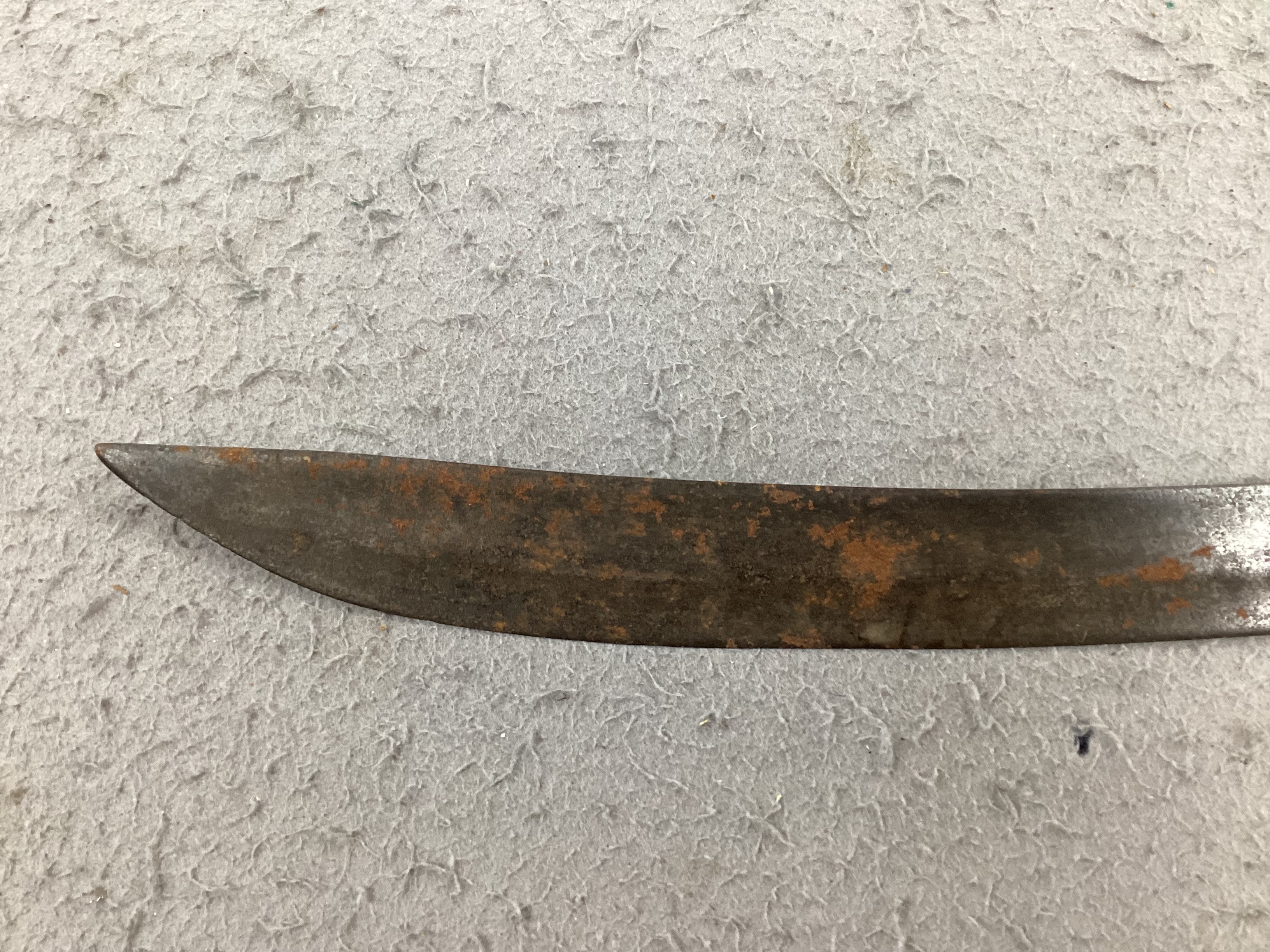 An English hangar, mid 17th century, curved fullered blade engraved with spurious date 1535 and running wolf mark, iron guard slightly reduced and swollen pommel, spirally carved and chequered bone grip, blade 67.5cm